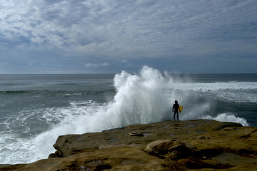 Fototapeta na wymiar Surfer Faces Crashing Wave