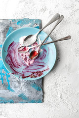 Plate, with the remains of food on a white textured background with art elements..