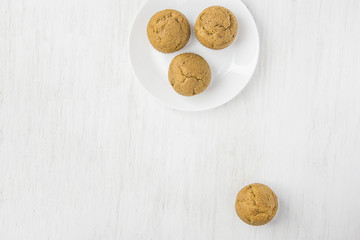 Homemade Whole Wheat Bran Muffin on White Plate. Breakfast Morning Healthy Pastry Baking Concept. Minimalist Style Copy Space for Text. Top View Flat Lay