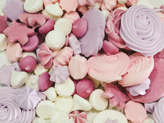 meringues. small white meringue sweets texture. sweets in pastel colors, pattern abstract on white background