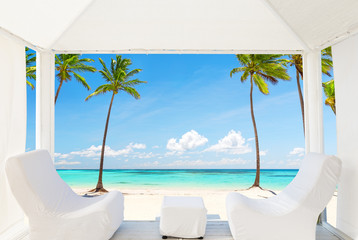 View of the beautiful beach through a Balinese bed
