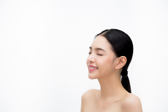Happy young beautiful and elegant Asian woman in side view isolated over white background, Healthcare and Skincare concept.