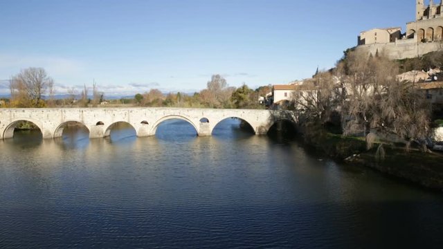 View of Cathedral of Saint Nazaire and Old Bridge across Orb river, Beziers, France