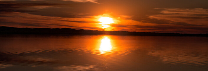 Panorámica de un atardecer en el lago
