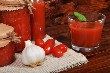 spicy and healthy tomato juice with garlic and basil seasoned for winter in jars with free space for text