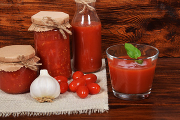 spicy and healthy tomato juice with garlic and basil seasoned for winter in jars with free space for text