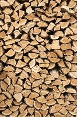 Stacked cut oak firewood closeup as background