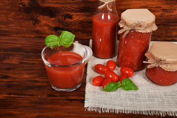 spicy and healthy tomato juice with garlic and basil seasoned for winter in jars with free space for text