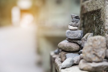 Soft focused of balance stone on the stone pole at temple.