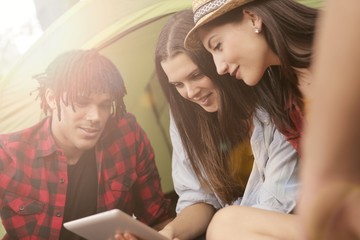 Three friends using a tablet