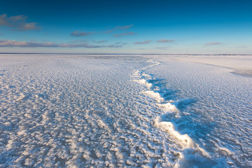 Ice and snow on the beach in the village of Chalupy in the Poland.