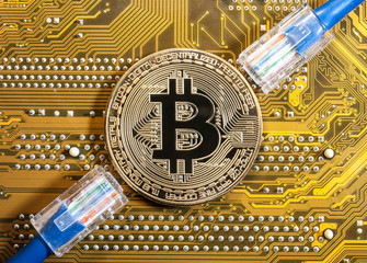 golden bitcoin coin on golden microchip close up