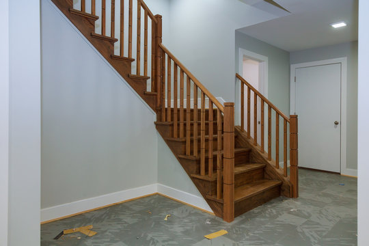 Hallway interior with hardwood floor. View of wooden stairs.