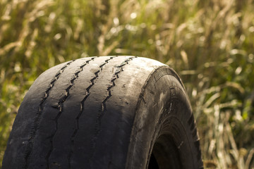 Close-up detail of car wheel tire badly worn and bald because of poor tracking or alignment of the...