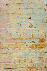Fototapeta premium Textured background of multi-layer flaking paint on the wall. Mixing different colors of paints in the cleaved layers on the surface. Grunge texture with a deep pattern