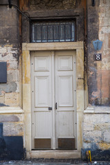 Fototapeta na wymiar Beautiful beige yellow vintage doors in an old european city