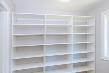 Fototapeta na wymiar installing wooden shelves on wall installing a shelf