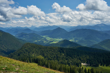 panoramic view at the bavarian alpes mountains with Jachenau under deep blue sky with white clouds