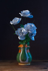Artificial roses in a creative vase,