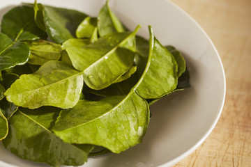 a bowl of kaffir lime leaves