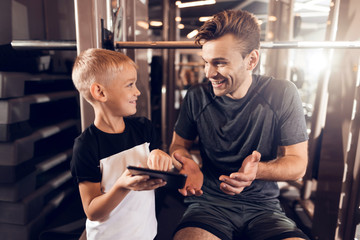 Father and son in the gym. Father and son spend time together and lead a healthy lifestyle.