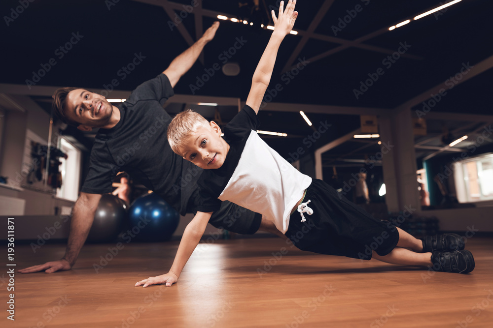 Wall mural father and son in the gym. father and son spend time together and lead a healthy lifestyle.