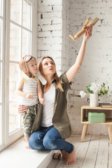 Mom and Son Having Fun at Home. Mother and Child Hugging and Playing Toys. Happy Loving Family