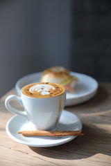 cappuccino or Latte art coffee made from milk on the wood table in coffee shop
