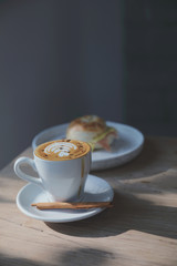 cappuccino or Latte art coffee made from milk on the wood table in coffee shop