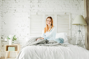 Cute Tender Woman in Sleepwear Sitting on Bed at Home. Smiling Girl Portrait