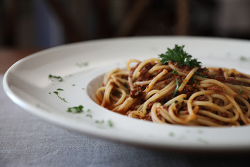 Spaghetti bolognese with beef tometo sauce on wood table , italian food
