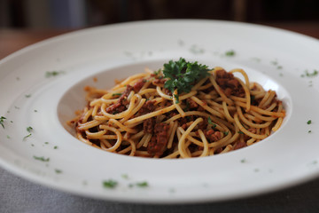 Spaghetti bolognese with beef tometo sauce on wood table , italian food