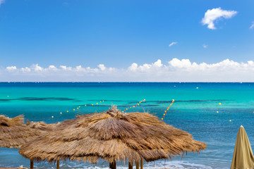 Thatched umbrellas on the beach cafe. Bali, Crete