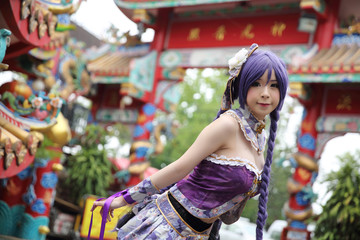 Obraz na płótnie Canvas Portrait of asian young woman dancing with purple Chinese dress cosplay with temple