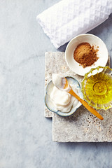 Natural cosmetics on gray stone background( face balm, argan oil and red clay)