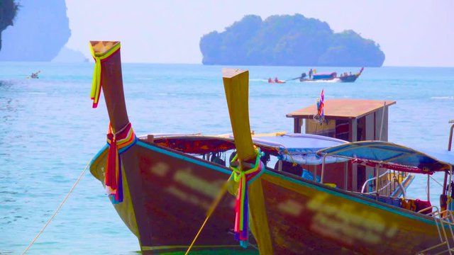 Moored Thai long-tailed boats in the turquoise waters of the Andaman Sea