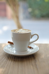 cappuccino or Latte art coffee made from milk on the wood table in coffee shop