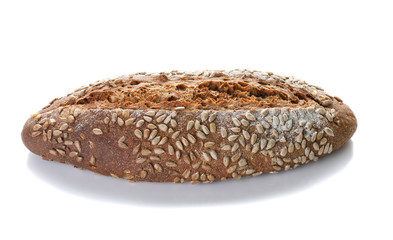 a loaf of unleavened bread with sunflower seeds close-up on a white background