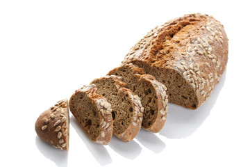 a loaf of unleavened bread with sunflower seeds close-up on a white background
