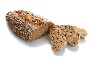 a loaf of unleavened bread with sunflower seeds close-up on a white background