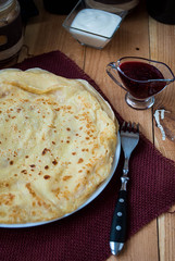 Russian pancakes with butter on a wooden table