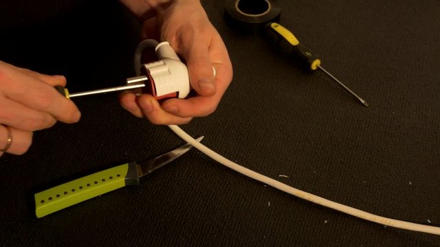 Close-up of a hand Electricians male contact or plug