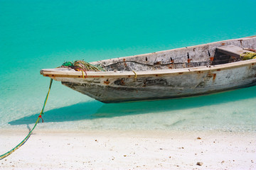 Wooden boat in azure water, Tanzania.