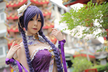 Portrait of asian young woman dancing with purple Chinese dress cosplay with temple - obrazy, fototapety, plakaty