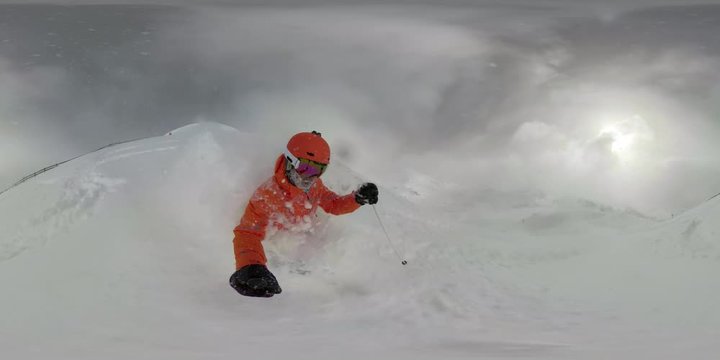 360VR man skiing in fresh powder snow on cloudy winter vacation day in mountains his beard full of snow
