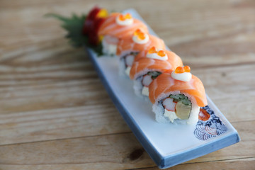 Sushi rolls with salmon on top , Japanese cuisine