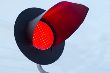 Traffic light shows red signal on railway. Red light
