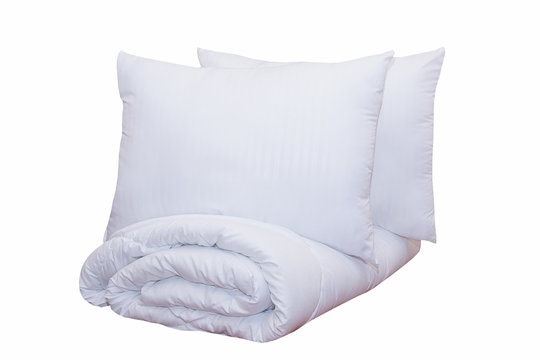 Roll of soft white blankets and white pillows isolated on white background