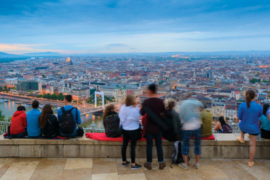 Group Of People Overlooking Budapest City From Top Viewing Point On Gellert Hill