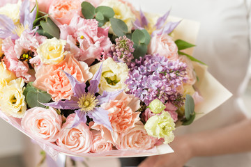 bouquet of delicate pastel color. beautiful luxury bunch of mixed flowers in womans hand. the work of the florist at a flower shop.